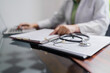 © Charlie's - Professional medical doctor in white uniform gown coat interview consulting patient.