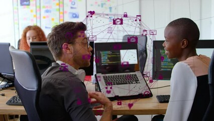 Sticker - Animation of globe of digital icons over diverse man and woman discussing over a laptop at office