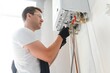 © Serhii - Professional plumber checking a boiler and pipes, boiler service concept