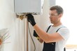 © Serhii - Professional boiler service: qualified technician checking a natural gas boiler at home