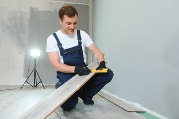 Man installing new laminated wooden floor