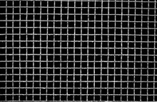 White Metal Mesh With Small Cells. Isolated On A Black Background. Close-up Image. Green  Painted Metal Grill.