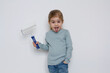 © strelov - Child paints home renovation spatula roller for painting walls