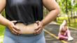 Close up stomach of oversize woman showing belly fat while exercise in park, Fat Woman Workout