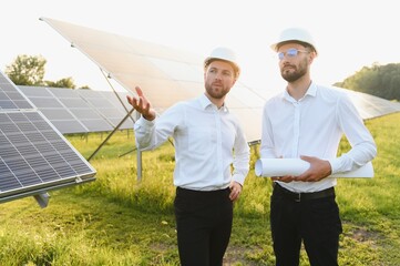 The solar farm(solar panel) with two engineers walk to check the operation of the system, Alternative energy to conserve the world's energy, Photovoltaic module idea for clean energy production