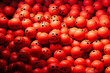 A pile of red balls with sad, depressed or angry expressions.