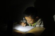 The boy studied accompanied by a candle