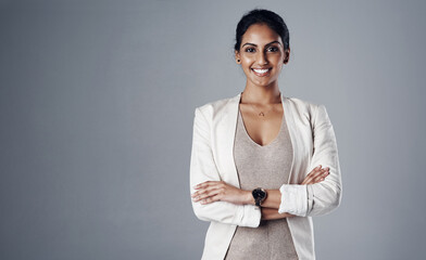 Space, arms crossed and portrait of business woman in studio for professional, natural and mockup. Happy, corporate and career with face of female employee on grey background for manager and pride