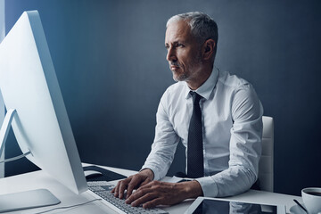 Poster - Computer, typing accountant and mature man in office, working and isolated on a studio background mockup. Tech, writing and serious manager at desktop for reading email, research or business auditor.
