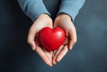 Caring Gesture Child's Hands Holding A Red Heart For Health Care Donation. AI