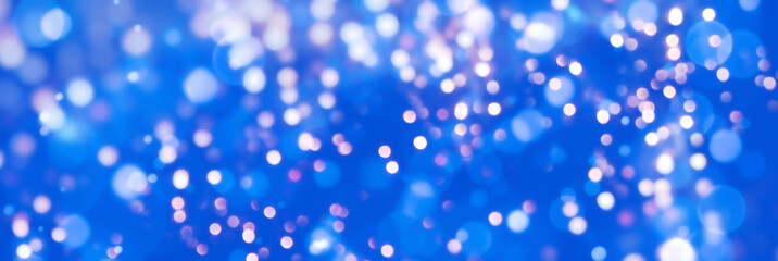 Wall Mural - abstract blue christmas bokeh light background -festive glowing new year header