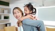 © M Stocker - Happy asian mother and cute little daughter playing piggybacking together having fun at home on weekend. Mother day concept, Happy family moment, Single mother