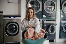 Young Woman Posing In A Laundry Room.