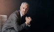 © Thurstan Hinrichsen/peopleimages.com - Mockup, chair and portrait of businessman, lawyer or attorney, confidence on dark background and studio space. Boss, ceo and professional business owner, proud senior executive director at law firm.
