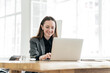 © muse studio - A woman uses a laptop computer workplace employee in the office. Happy man assistant online job.