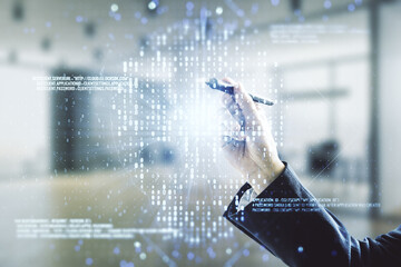 Poster - Man hand with pen working with abstract virtual code skull illustration on blurred office background. Hacking and phishing concept. Multiexposure