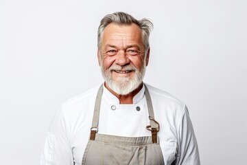 Wall Mural - Portrait of a senior man wearing apron standing isolated over white background