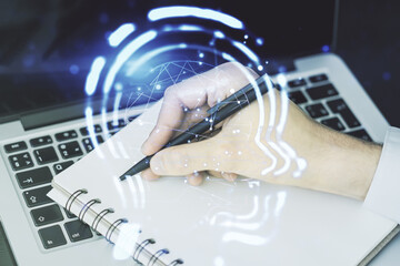 Poster - Creative artificial Intelligence concept with human head hologram and hand writing in notebook on background with laptop. Multiexposure