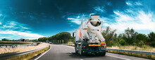 Panorama Panoramic View Special Concrete Transport Truck In-transit Mixer Unit In Motion On Country Road, Freeway. Freeway Motorway Highway. Business Drive Transportation And Development Concept