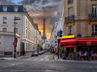 Wall Mural - cozy street with tables of cafe and eiffel tower in paris, france. architecture and landmark of pari
