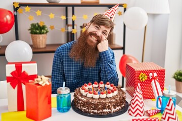 Wall Mural - young redhead man celebrating birthday sitting on table at home