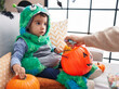 © Krakenimages.com - Adorable hispanic boy having halloween party holding sweets at home