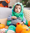 © Krakenimages.com - Adorable hispanic boy having halloween party holding sweets at home