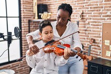 African American Mother And Son Student Learning Play Violin At Music Studio