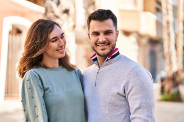 Poster - Man and woman smiling confident hugging each other standing at street