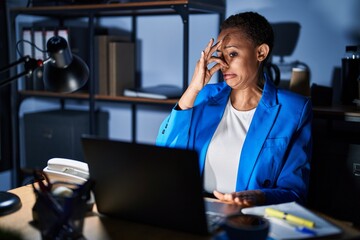 Sticker - Beautiful african american woman working at the office at night smelling something stinky and disgusting, intolerable smell, holding breath with fingers on nose. bad smell