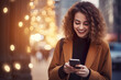 © Ployker - Young beautiful woman using smartphone in a city. Smiling student girl texting on mobile phone outdoor.