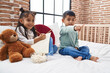 © Krakenimages.com - Adorable boy and girl sitting on bed drawing on notebook at bedroom