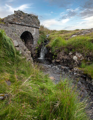 Wall Mural - Westcoast Ireland. Conemara. Peat and heather fields. Foggy. Stone bridge and small stream.