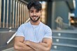 © Krakenimages.com - Young hispanic man smiling confident standing with arms crossed gesture at street