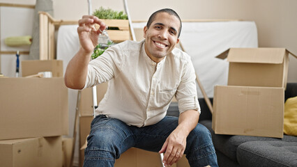 Poster - Young hispanic man smiling confident holding new house keys at new home