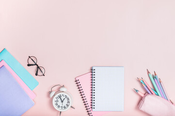 Wall Mural - Flat lay composition with school supplies in pastel colors on a pink background. Pencil case with pencils and pens.