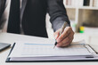 © skarie - Businessman pointing monthly graph chart. Data analyzing to find out the result. Businessman writing or pointing on report paper. Business strategy concept.