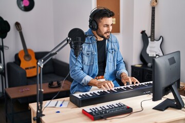 Sticker - Young hispanic man composer composing song at music studio