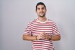 © Krakenimages.com - Hispanic man with long hair standing over isolated background hands together and fingers crossed smiling relaxed and cheerful. success and optimistic