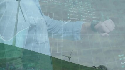 Poster - Animation of stock market data processing over spinning windmill against man using smartwatch