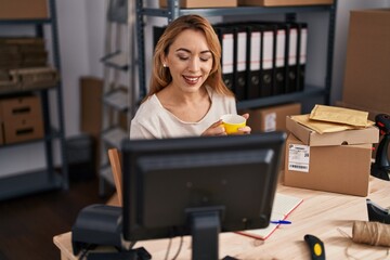 Young woman ecommerce busines worker drinking coffee at office