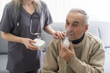 Elderly Senior Man Nursing Care Wear Oxygen Inhaler Device For Helping Breath Respiratory. Oxygen Concentrator Portable
