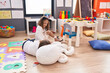© Krakenimages.com - Adorable boy and girl students sitting on table smiling confident at kindergarten