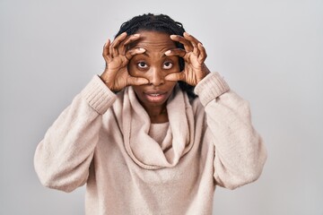 Poster - African woman standing over white background trying to open eyes with fingers, sleepy and tired for morning fatigue