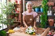 © Krakenimages.com - Middle age grey-haired woman florist make bouquet of flowers at florist