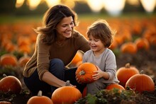 Mother And Son Playing At A Pumpkin Patch Field