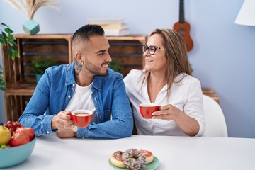 Canvas Print - Man and woman mother and son drinking coffee at home