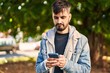 © Krakenimages.com - Young hispanic man using smartphone at park