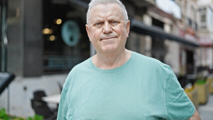 Wall Mural - Middle age grey-haired man smiling confident standing at coffee shop terrace