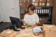 © Krakenimages.com - Young beautiful hispanic woman ecommerce business worker eating salad at office